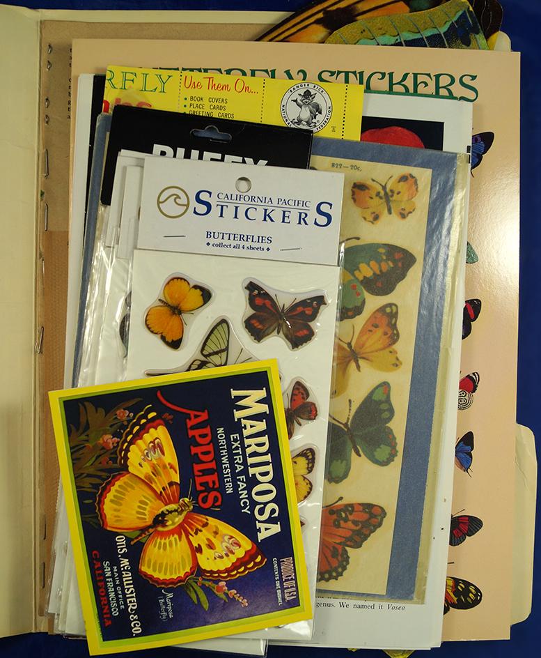 Large lot of butterfly stickers, postcards, and stamps.