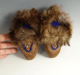 Contemporary Native American small childrens partially beaded Moccasins with dyed rabbit cuffs.