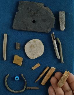 Group of assorted artifacts found near the Columbia River including bone, stone and trade beads. Lar