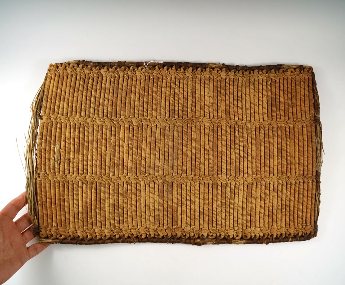 16" tall by 11" wide woven African mat that would make a nice wall display.