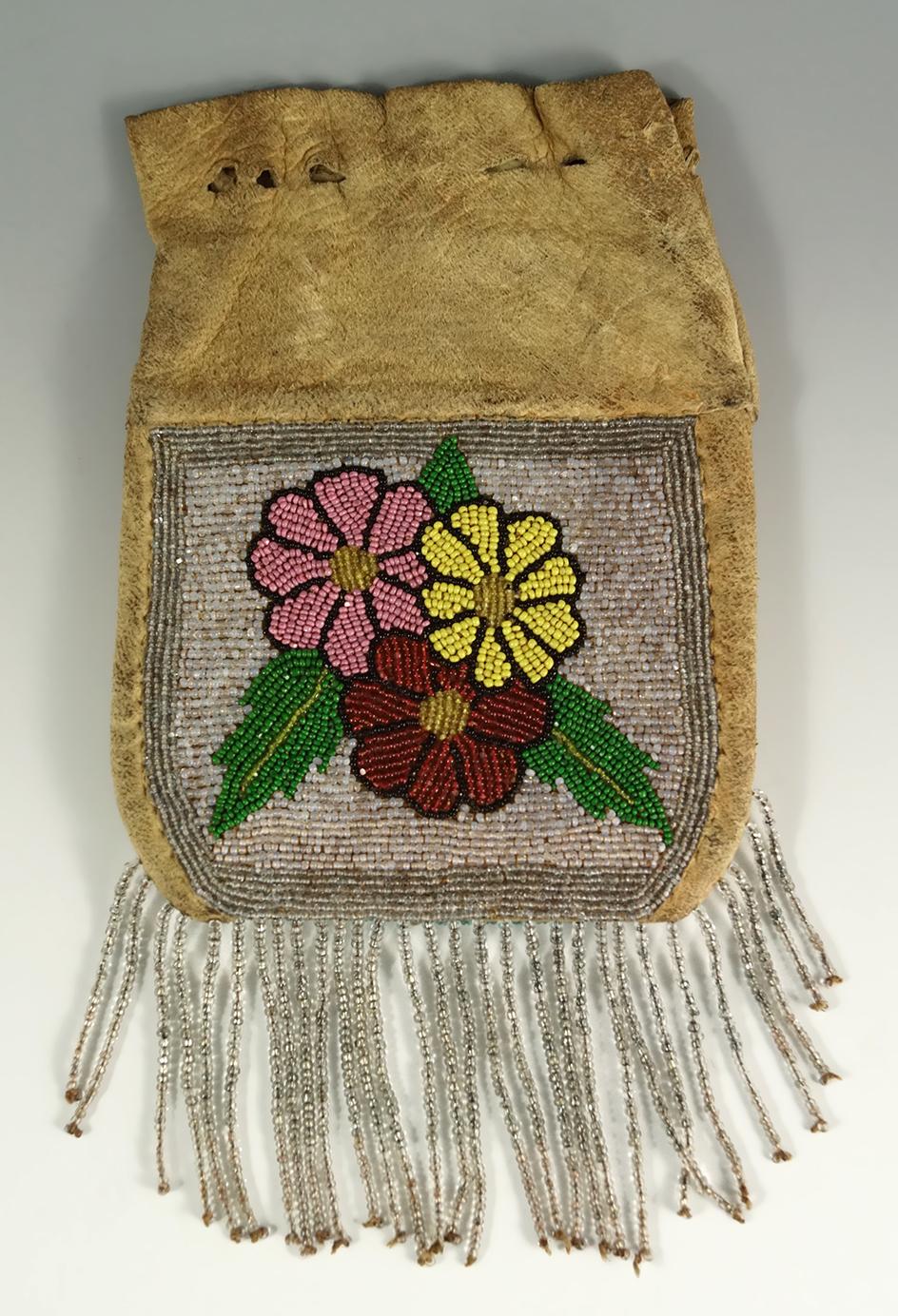 6" tall leather Plateau Purse with nicely beaded drops. Circa 1900.