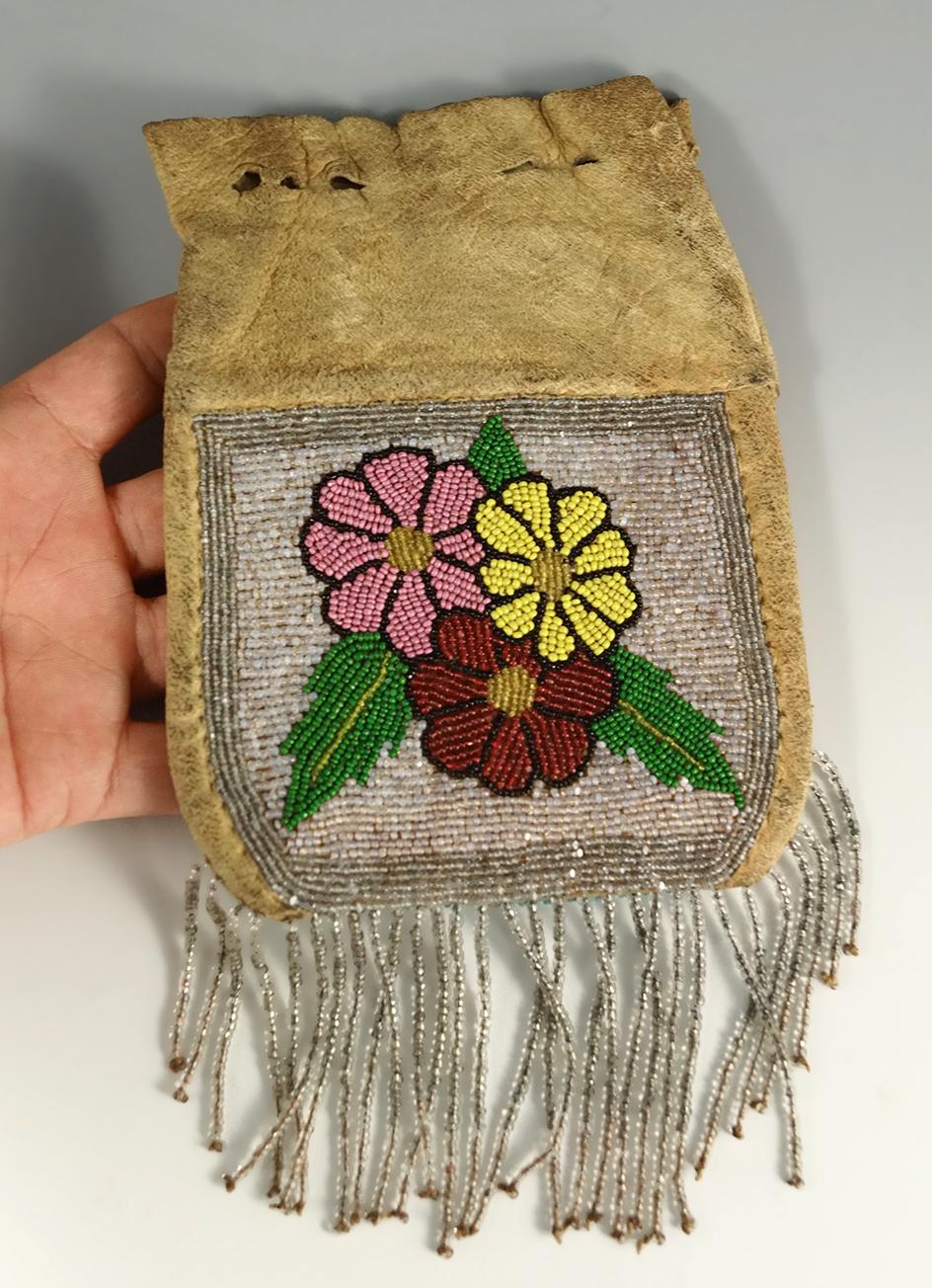 6" tall leather Plateau Purse with nicely beaded drops. Circa 1900.