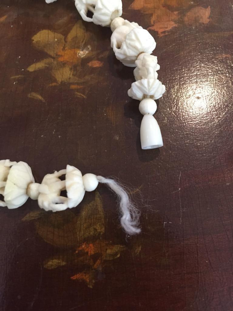 Vintage resin and bone figures incl. 3 netsukes, Hawaiian flower necklace, and 2 more figures