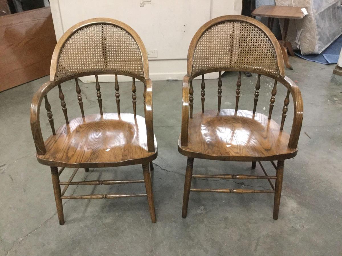 Set of two unique vintage oak spindle back and cane back bent arm dining chairs