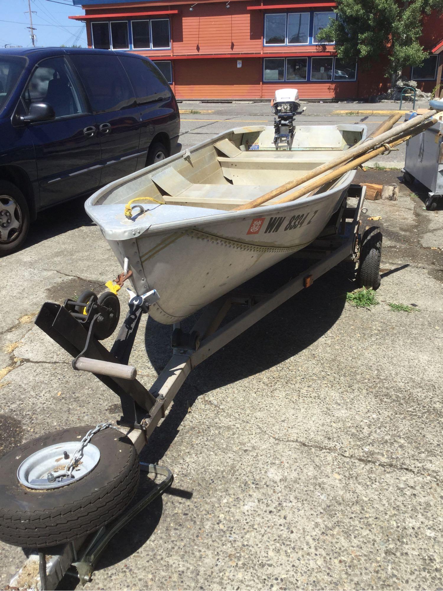 Sears steel boat model no. 61823 with Evinrude Lightwin outboard motor and trailer