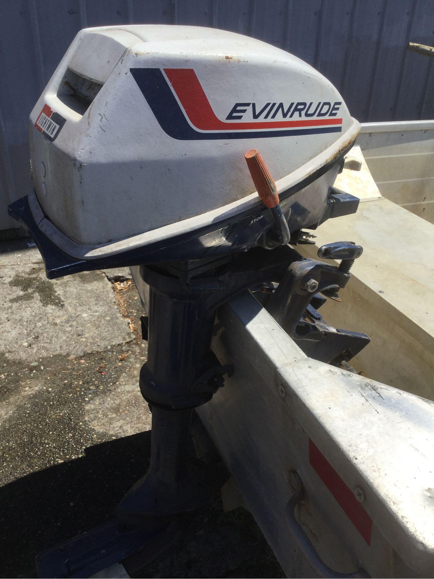 Sears steel boat model no. 61823 with Evinrude Lightwin outboard motor and trailer