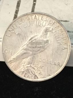 1922 and a 1923-S silver Peace dollars