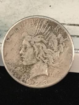 1922 and a 1923-S silver Peace dollars