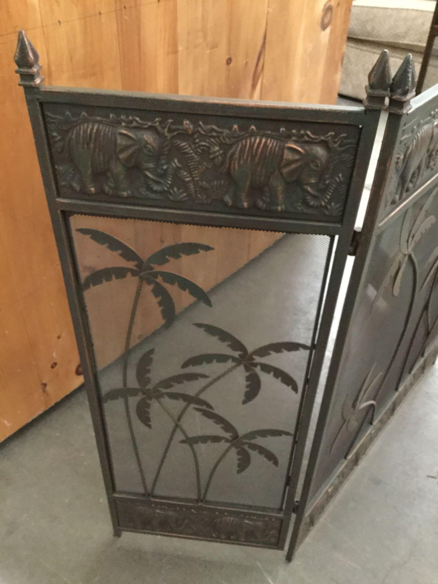 Bronzed African elephant and palm tree motif fireplace screen with brass fireplace set
