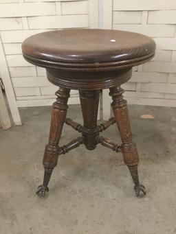 Antique wood swivel stool with glass ball and metal claw foot design