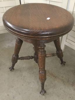 Antique wood swivel stool with glass ball and metal claw foot design