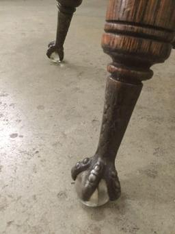 Antique wood swivel stool with glass ball and metal claw foot design