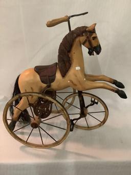 Antique composite/ metal horse tricycle sized for dolls, approximately 12 x 22 x 23 inches. Missing