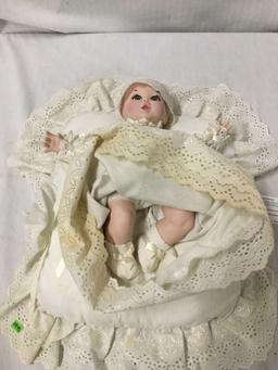 Vintage porcelain Baby doll with pillow signed c400. Measures approximately 14x13x2 inches.