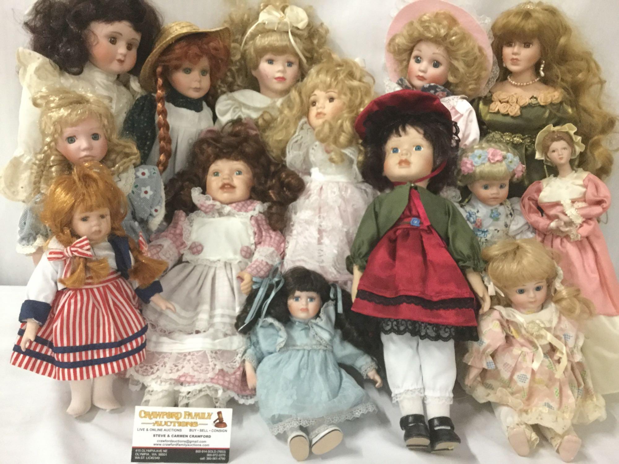 Fourteen porcelain and composite dolls from makers like Swan Collection. Largest doll is approx.