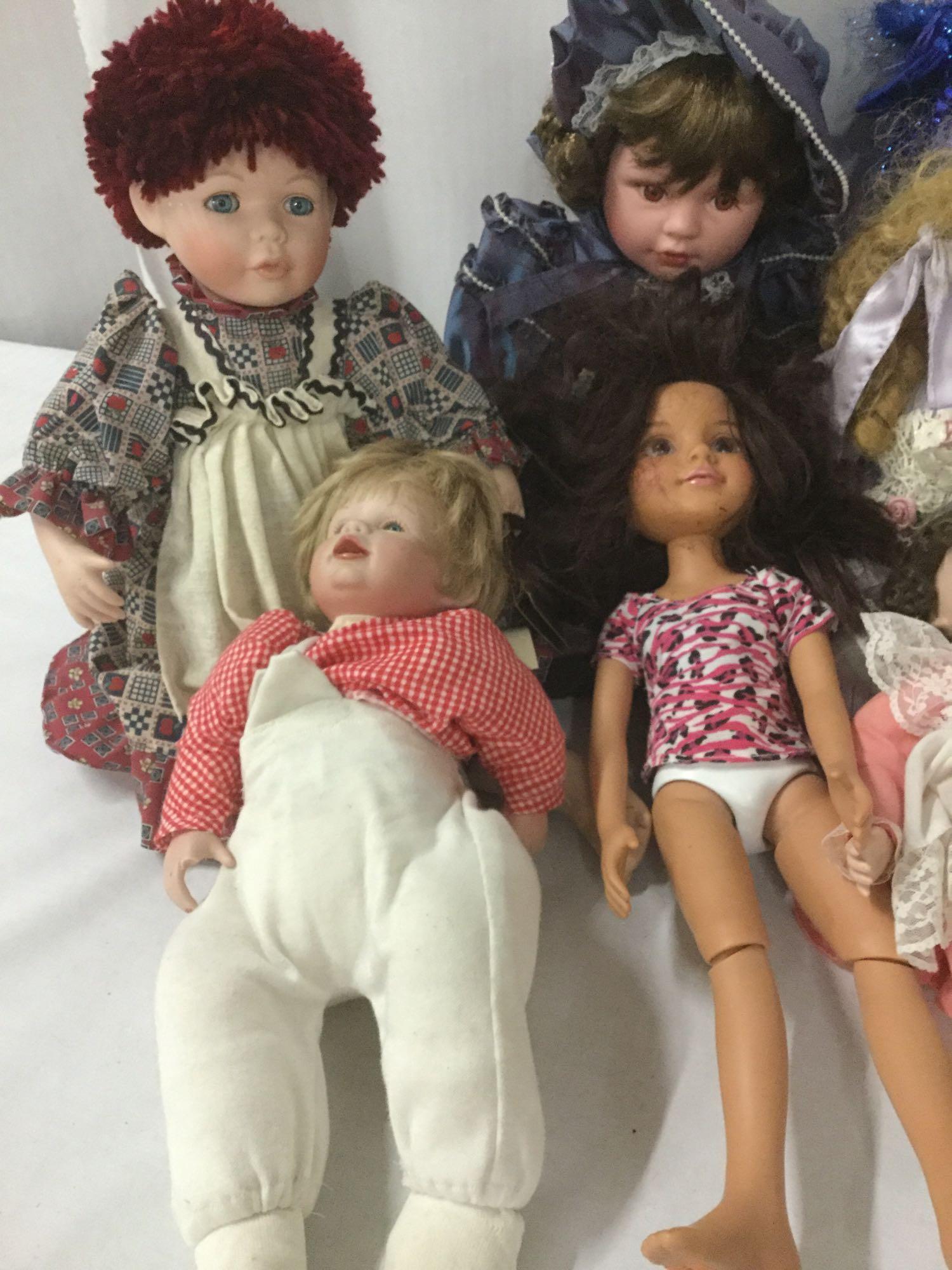 Nine porcelain, vinyl, and composite dolls from makers like Mattel, House of Roses, MGA