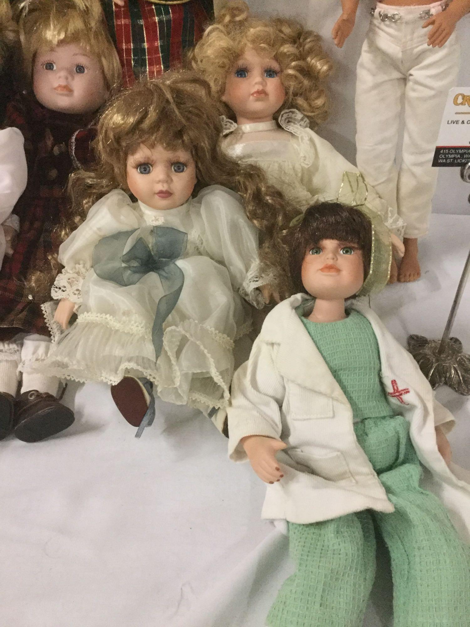 Twelve porcelain, vinyl, and composite dolls from Mattel, Court of Dolls, and others. JRL