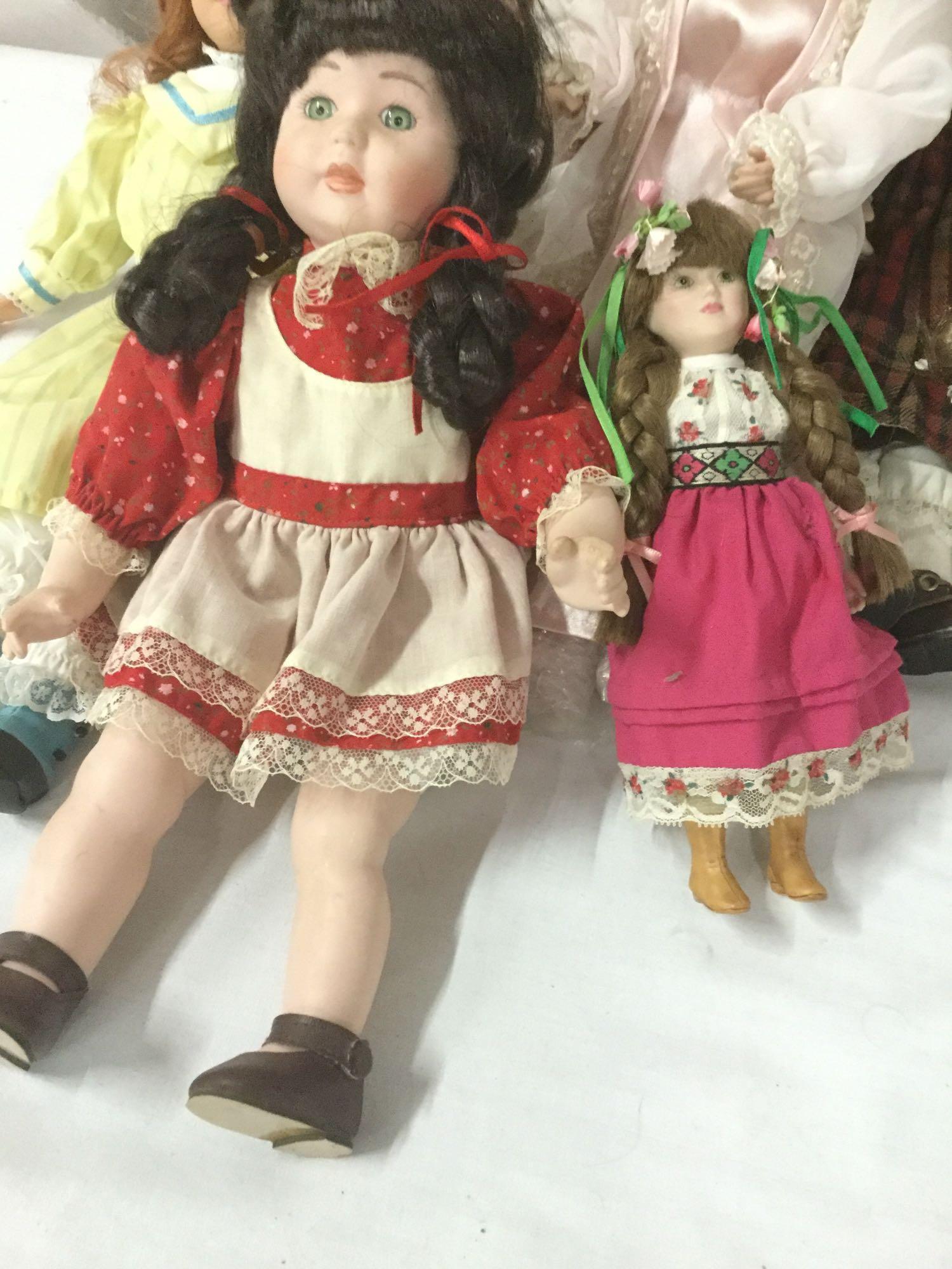 Twelve porcelain, vinyl, and composite dolls from Mattel, Court of Dolls, and others. JRL