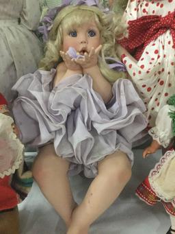 Six composite, vinyl, and porcelain dolls from House of Roses, Traditions, and others. JRL