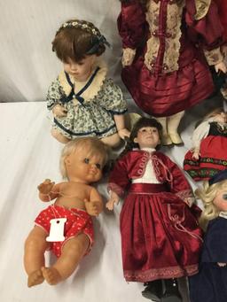 11x porcelain, composite and vinyl dolls. Famosa, Crowne and more. Largest doll measures