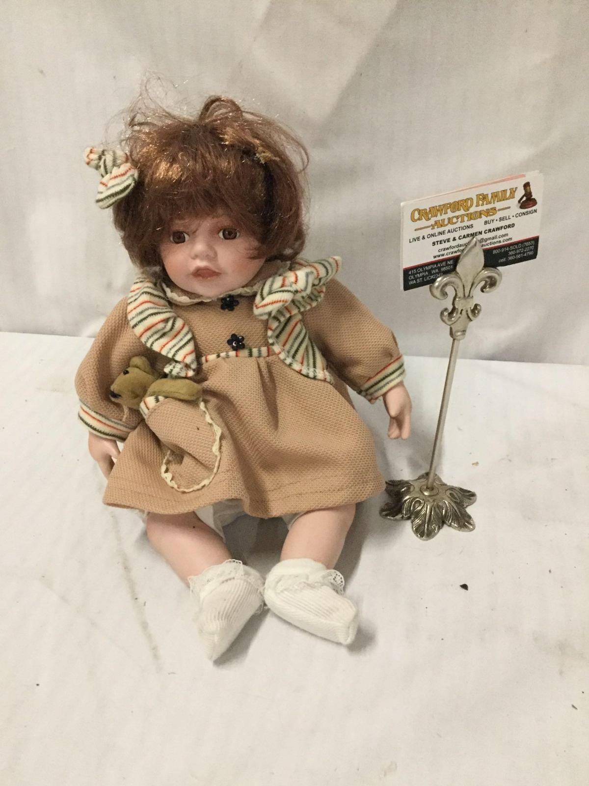 Duck House Heirloom porcelain doll. Numbered 184/5000. Measures approximately 14x9x9 inches.