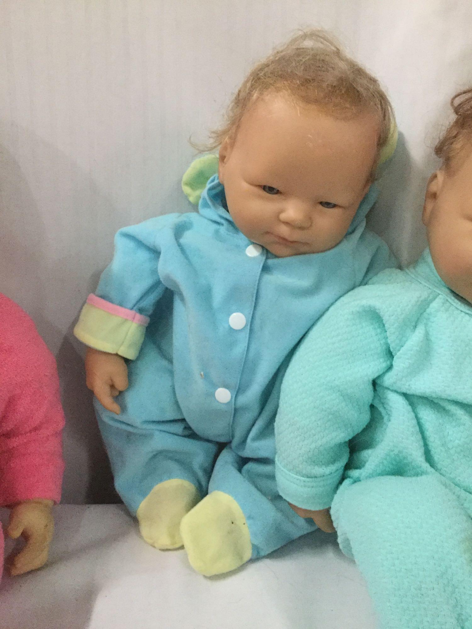 Six vinyl and composite baby dolls from makers like World Doll and Berenguer. Largest doll approx.