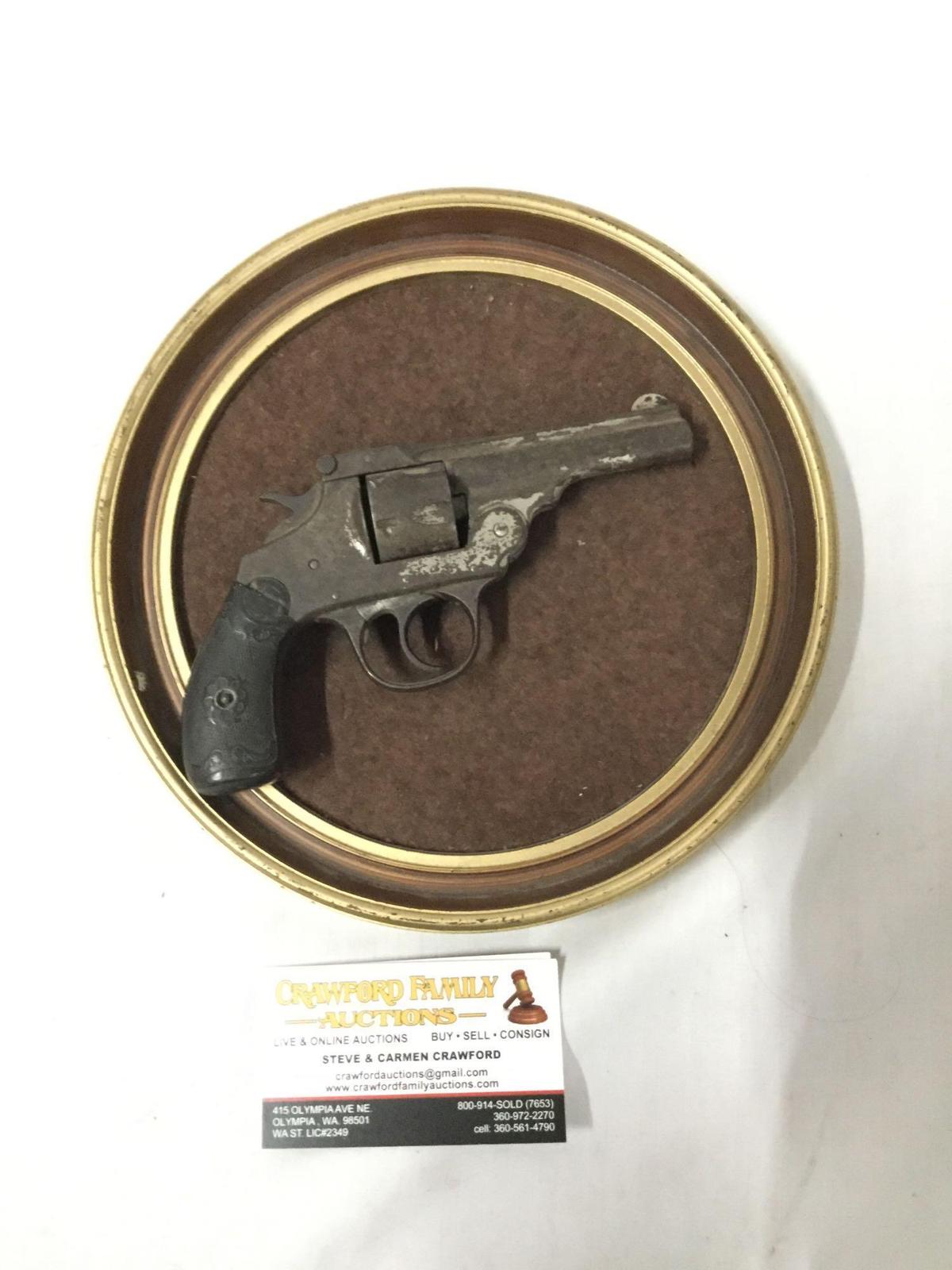 Antique revolver mounted on a wall plate