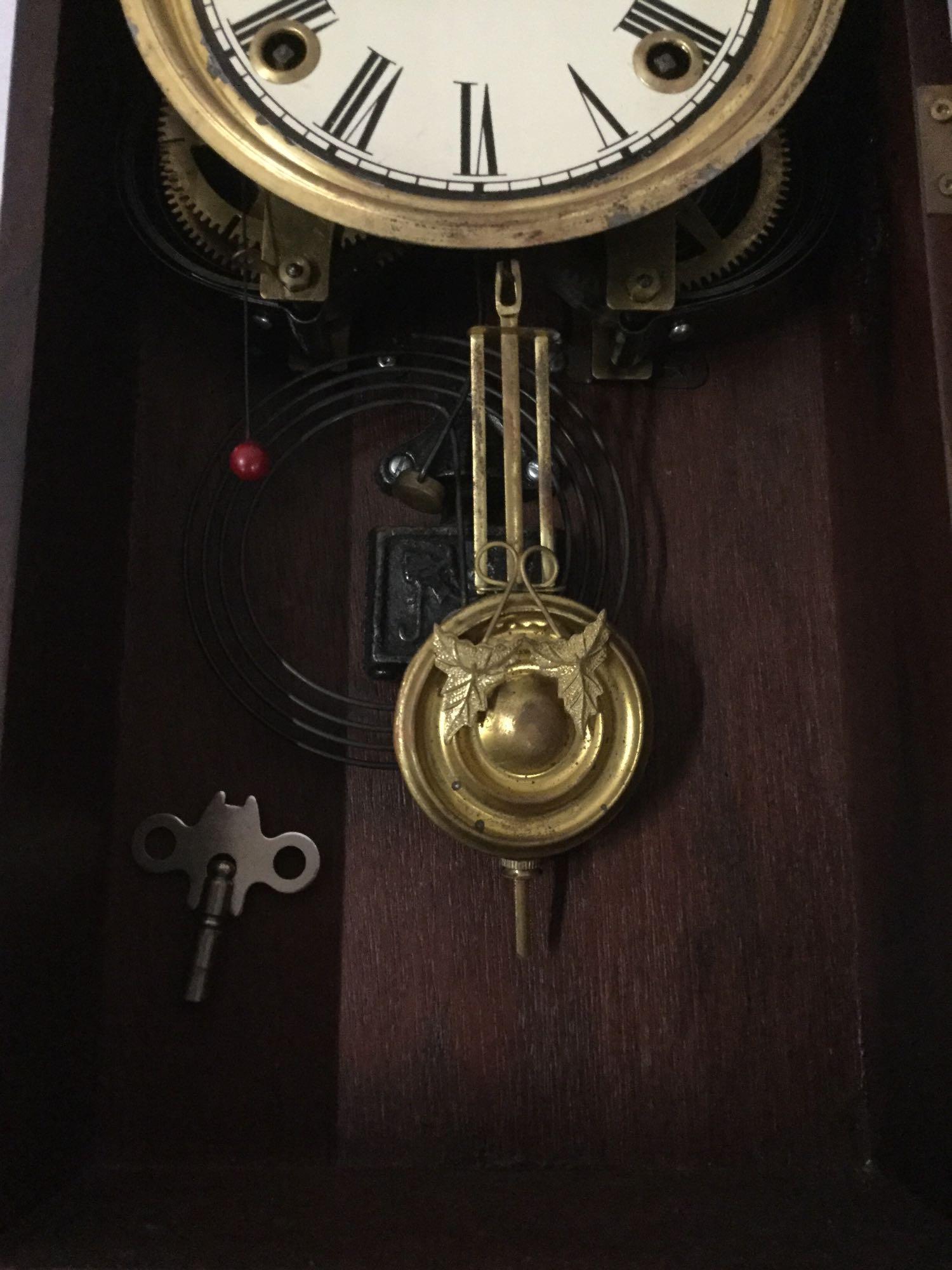 Antique time strike mantle clock with unique molding, floral design glass front & has pendulum/key