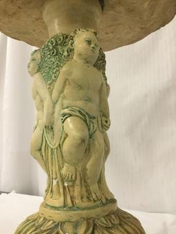 Vintage composite lounge lamp table ringed with cupid sculptures - some damage and chipping