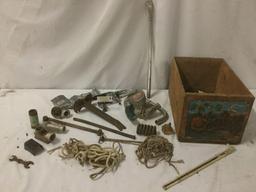 Antique and vintage misc. items in an orange crate, incl. a Scotts Zephyr cranking machine, ropes,