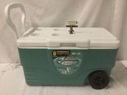 Coleman Unltimate Xtreme 50 qt cooler with four cup holders, wheels, drain, and 72 cans of beer