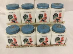 Collection of 30s and 40s Tipp City glass spice shakers with metal carrying stands. Rooster,