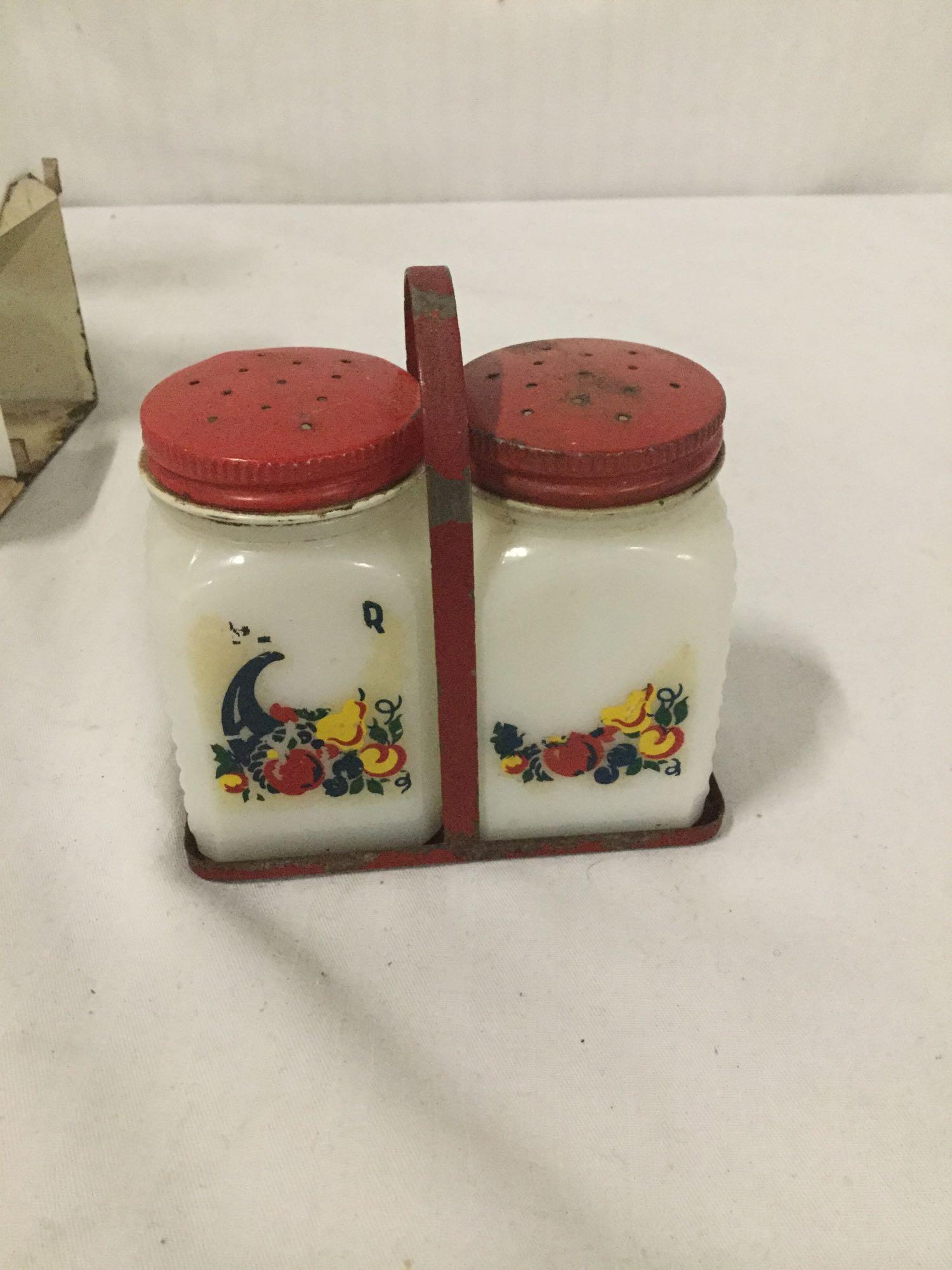 Collection of 30s and 40s Tipp City glass spice shakers with metal carrying stands. Rooster,