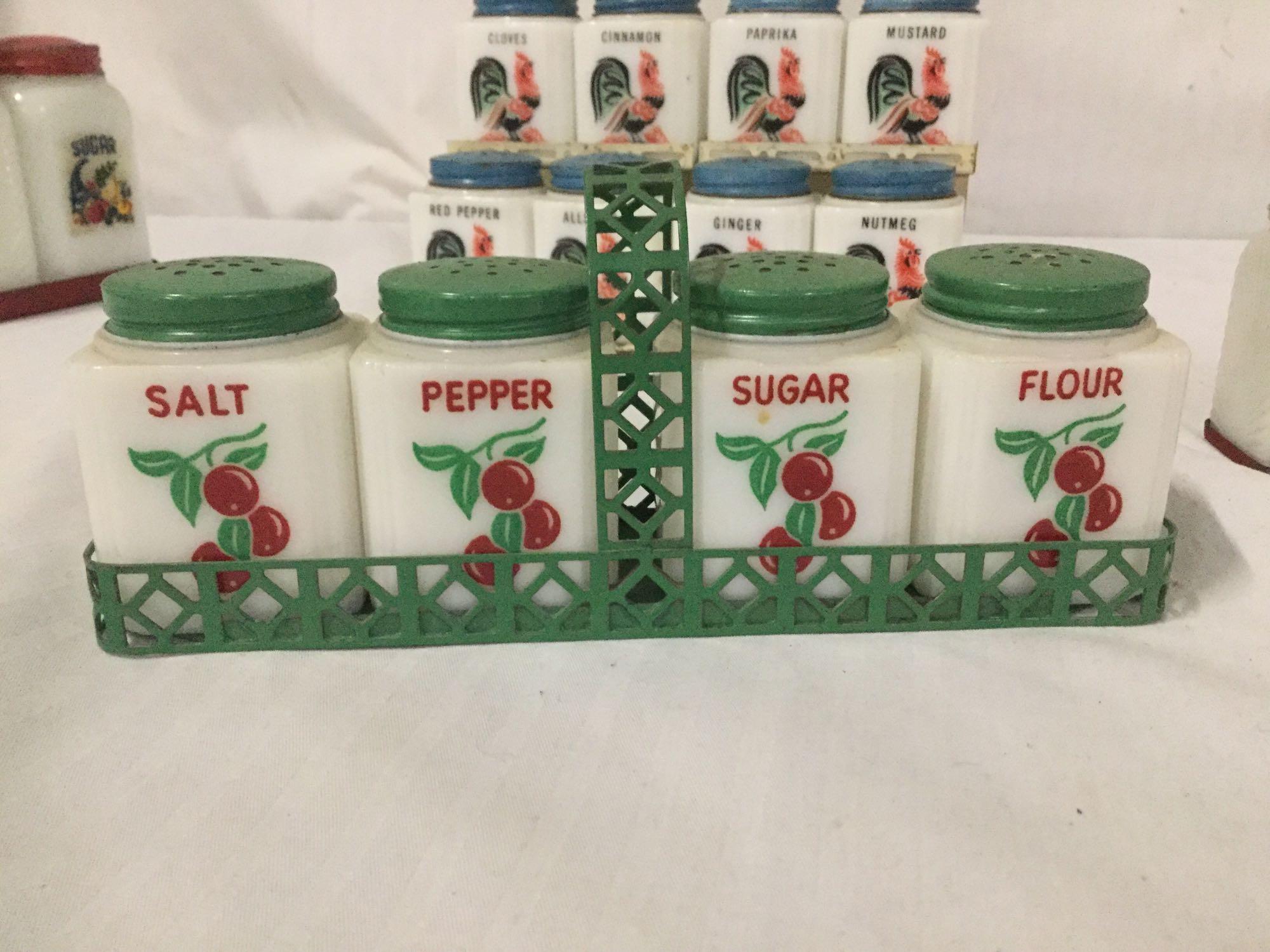 Collection of 30s and 40s Tipp City glass spice shakers with metal carrying stands. Rooster,