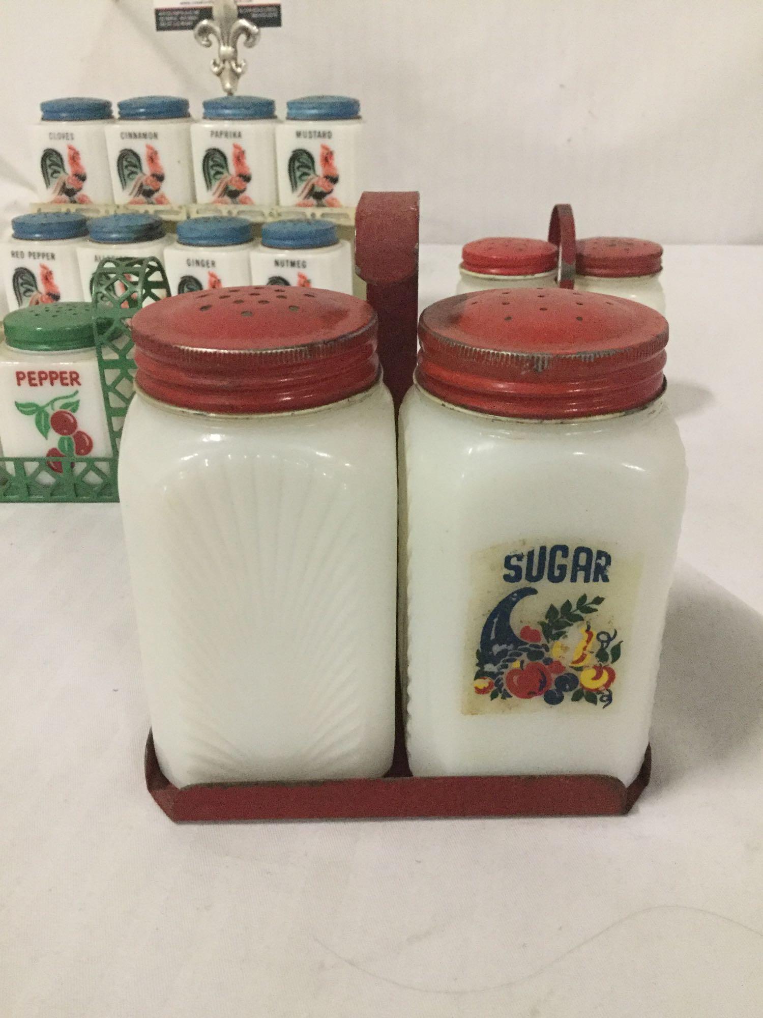 Collection of 30s and 40s Tipp City glass spice shakers with metal carrying stands. Rooster,