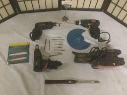 Three drills, electric sander, ten drill bits, and several misc. tools.