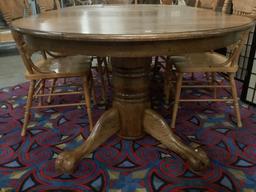 Antique style oak pedestal base claw foot dining table with 2 cleaves & 6 matching carved chairs