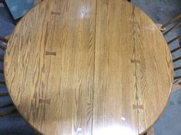 Vintage Conant Ball Furniture Co. round oak table with four chairs and two leaves. approx 44x44x30