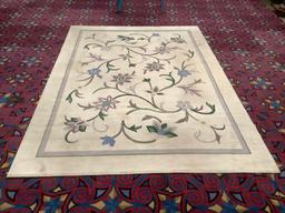 Wool rug with floral pattern. Has some staining. Measures approx 134x92 inches....