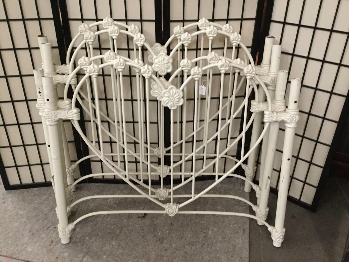 Pair of vintage twin sized metal bed frames w/ heart shaped/flower motif. No rails.