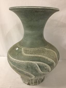 Vintage green ceramic vase w/ swirling incised designs, approx. 13x13x18.5 inches.