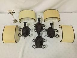 Collection of four wall mounted light fixtures with shades.