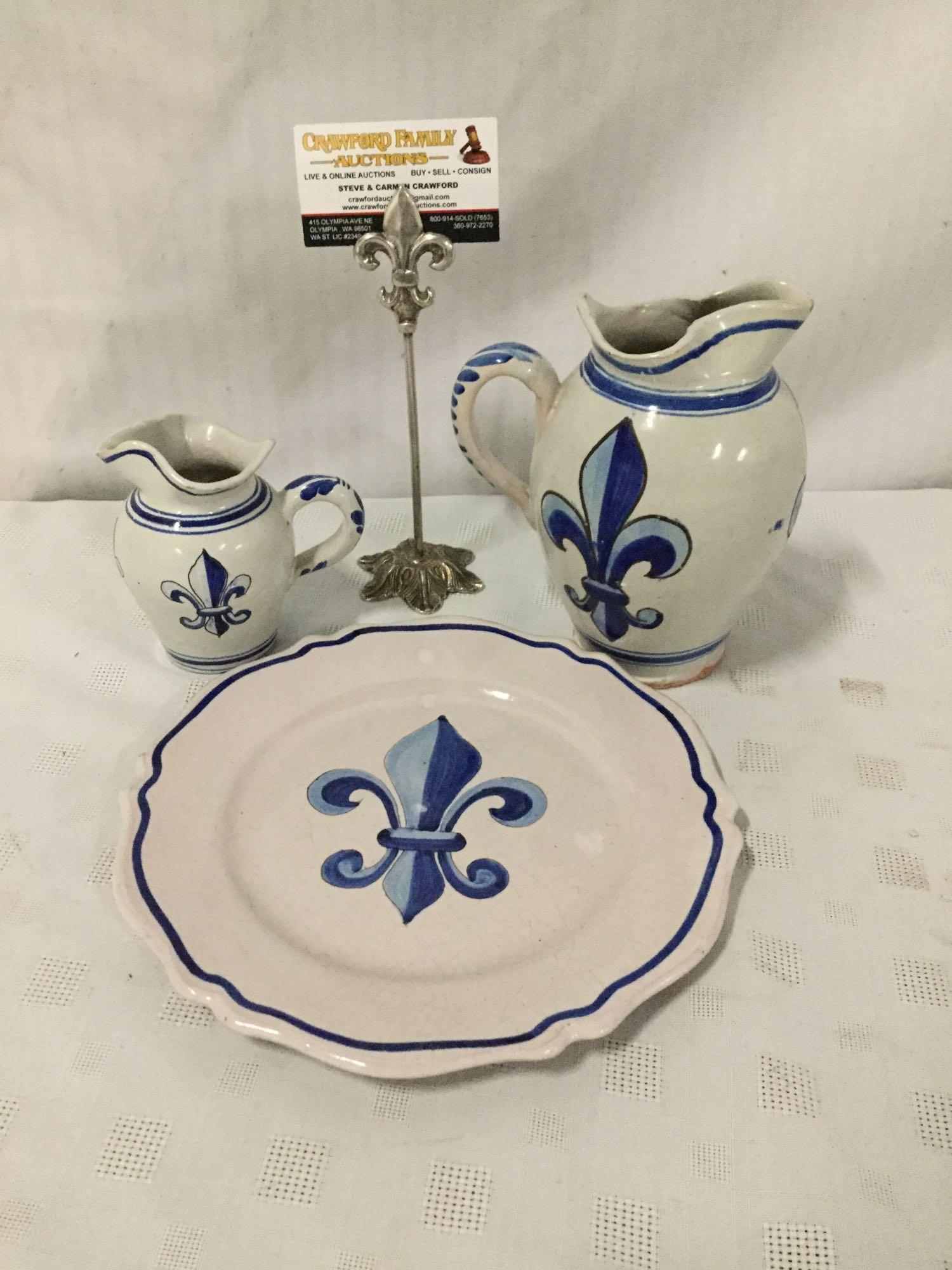 Set of three stoneware fleur-de-lis motif pieces signed by artist.