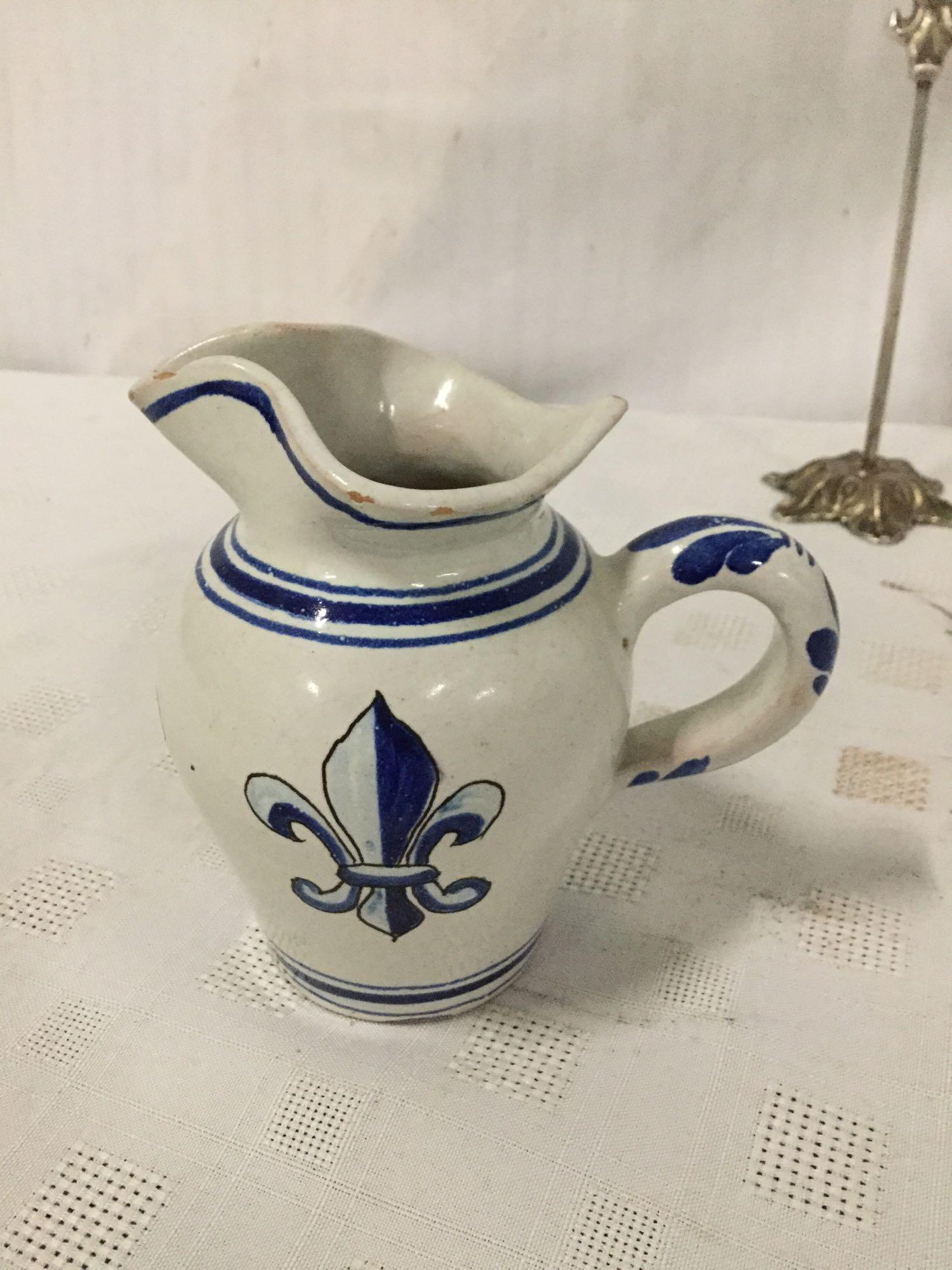 Set of three stoneware fleur-de-lis motif pieces signed by artist.