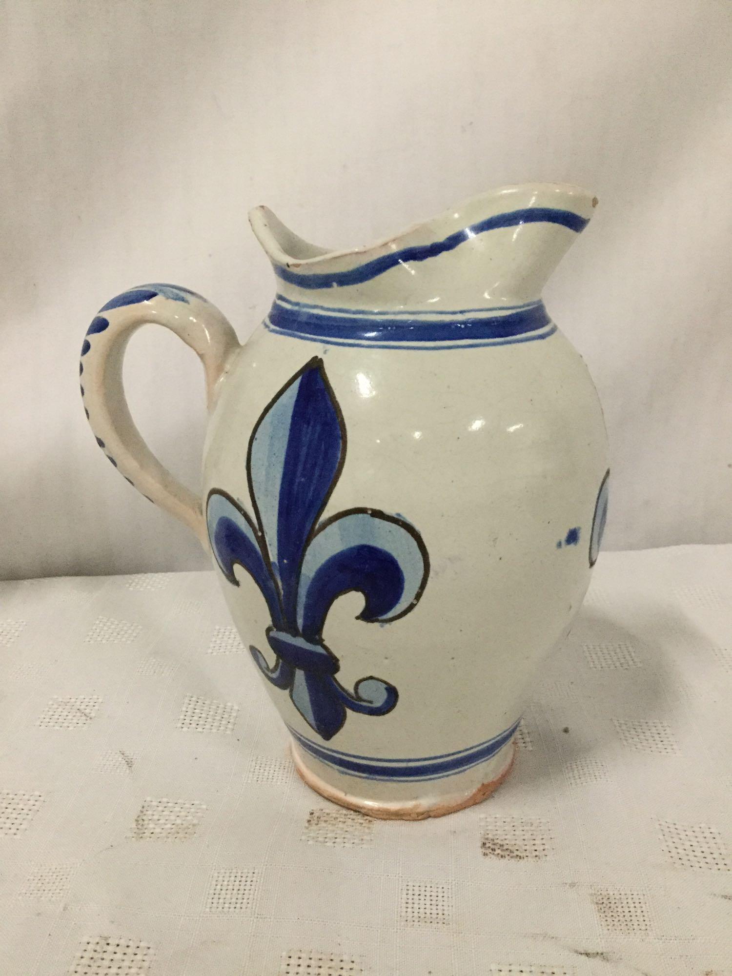 Set of three stoneware fleur-de-lis motif pieces signed by artist.