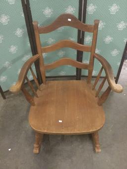 Vintage wide wooden rocking chair.