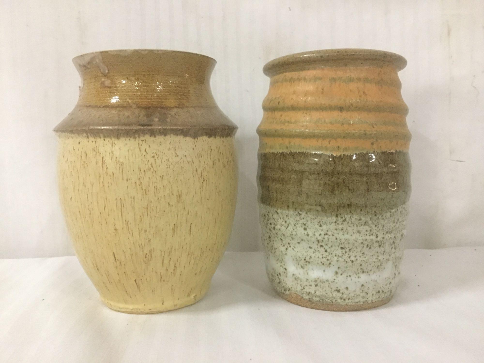 Two stoneware pottery vases, signed by unknown artists, approx. 6x6x8 inches each.