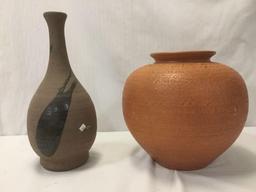 2 stoneware vases; large round orange vase & thin black sparsely glazed vase, approx 13x13x12 inches