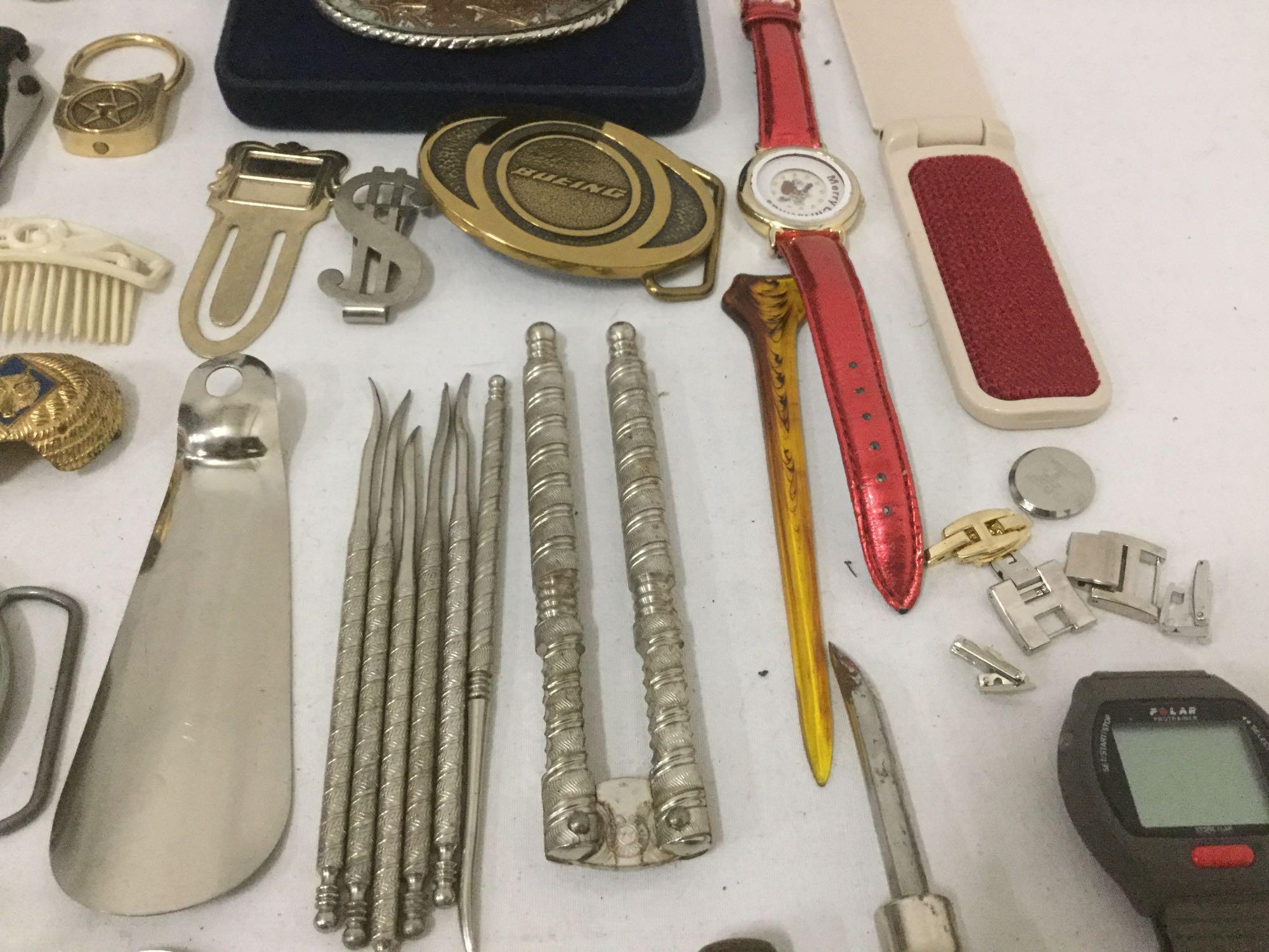 Large bag of mixed items: pocket knife, belt buckles, watches, sun dial & more