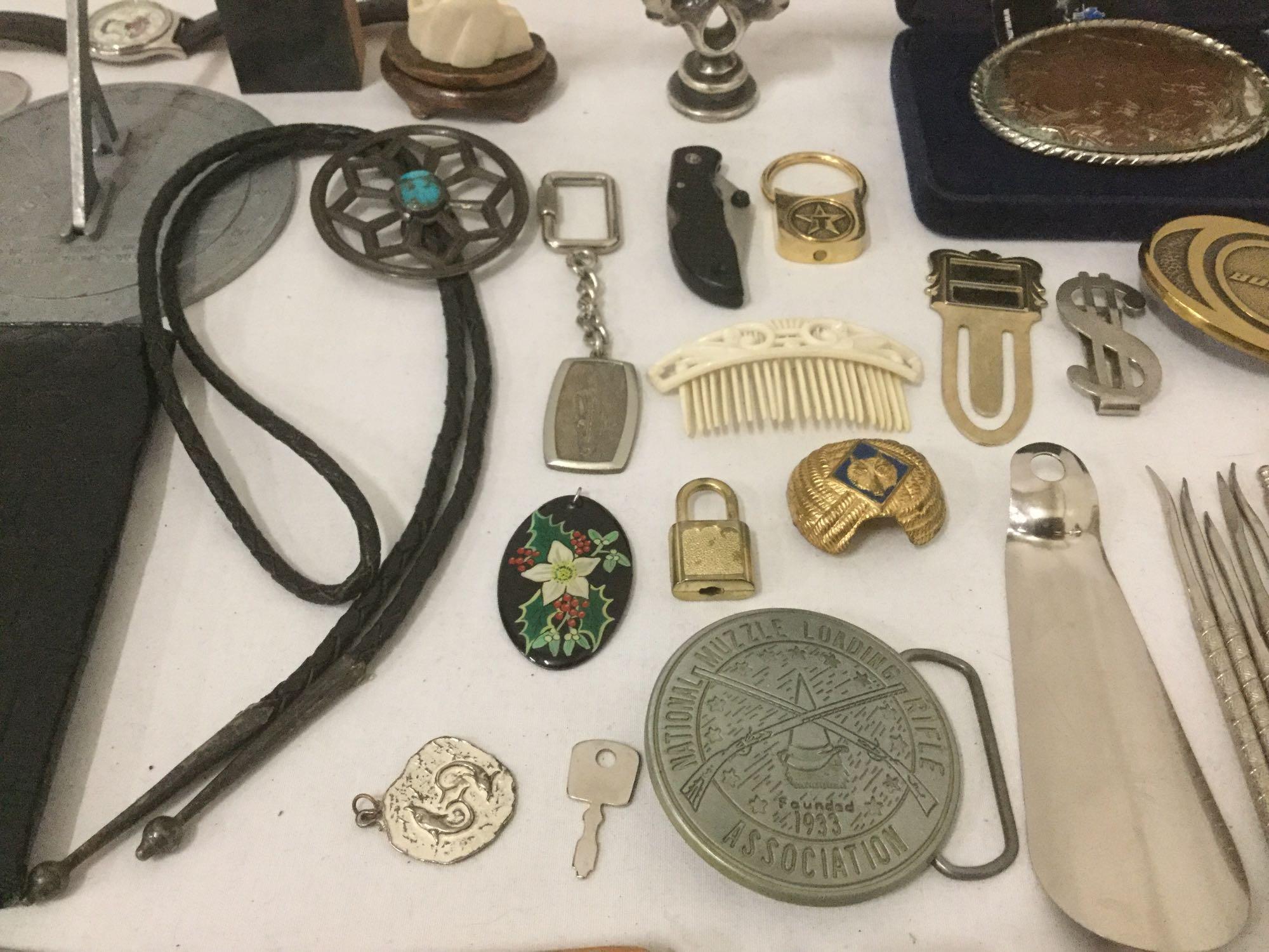 Large bag of mixed items: pocket knife, belt buckles, watches, sun dial & more